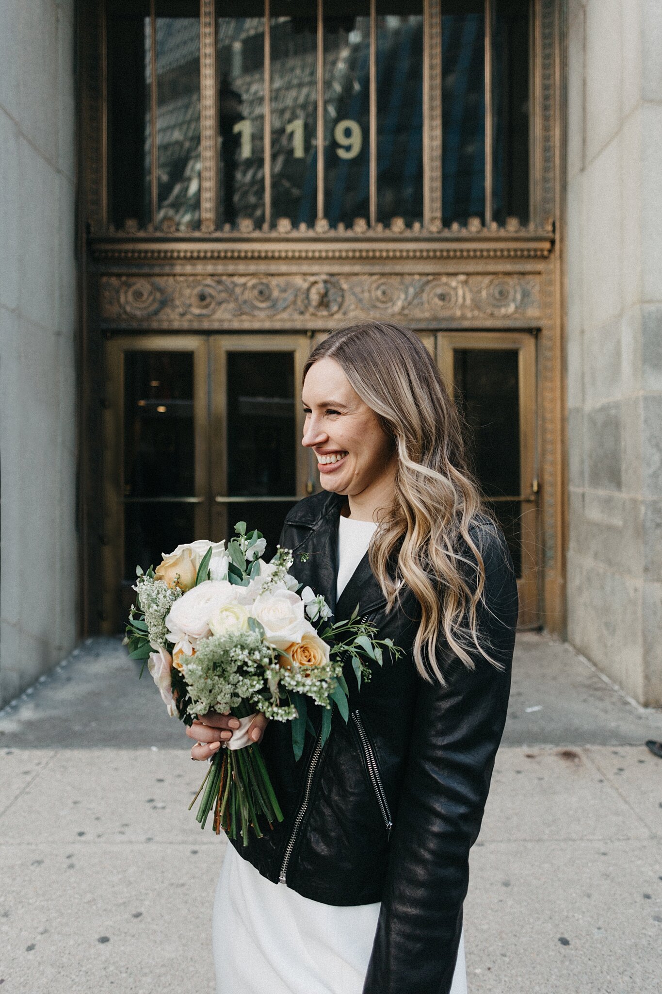 bride smiling by City Hall Chicago sign