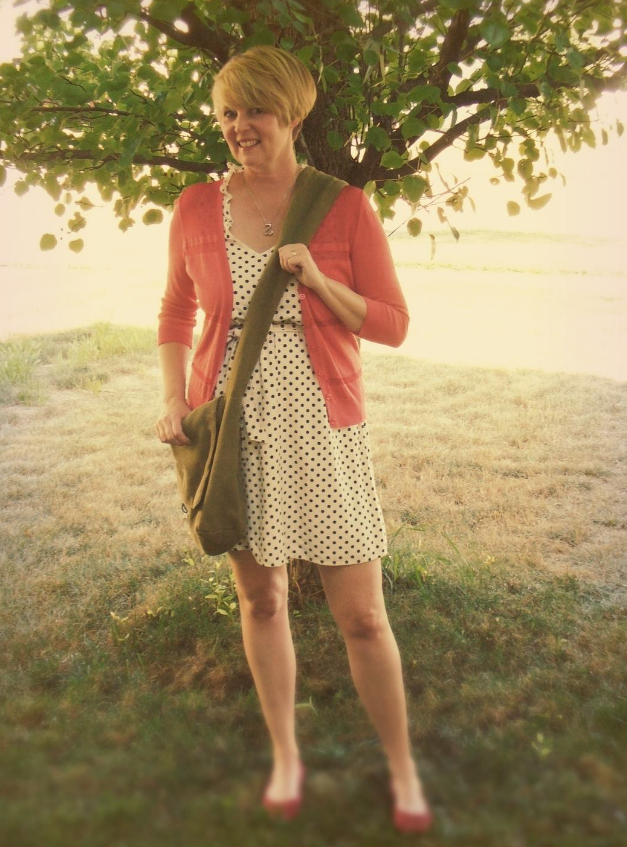old photo of woman standing under a tree before class