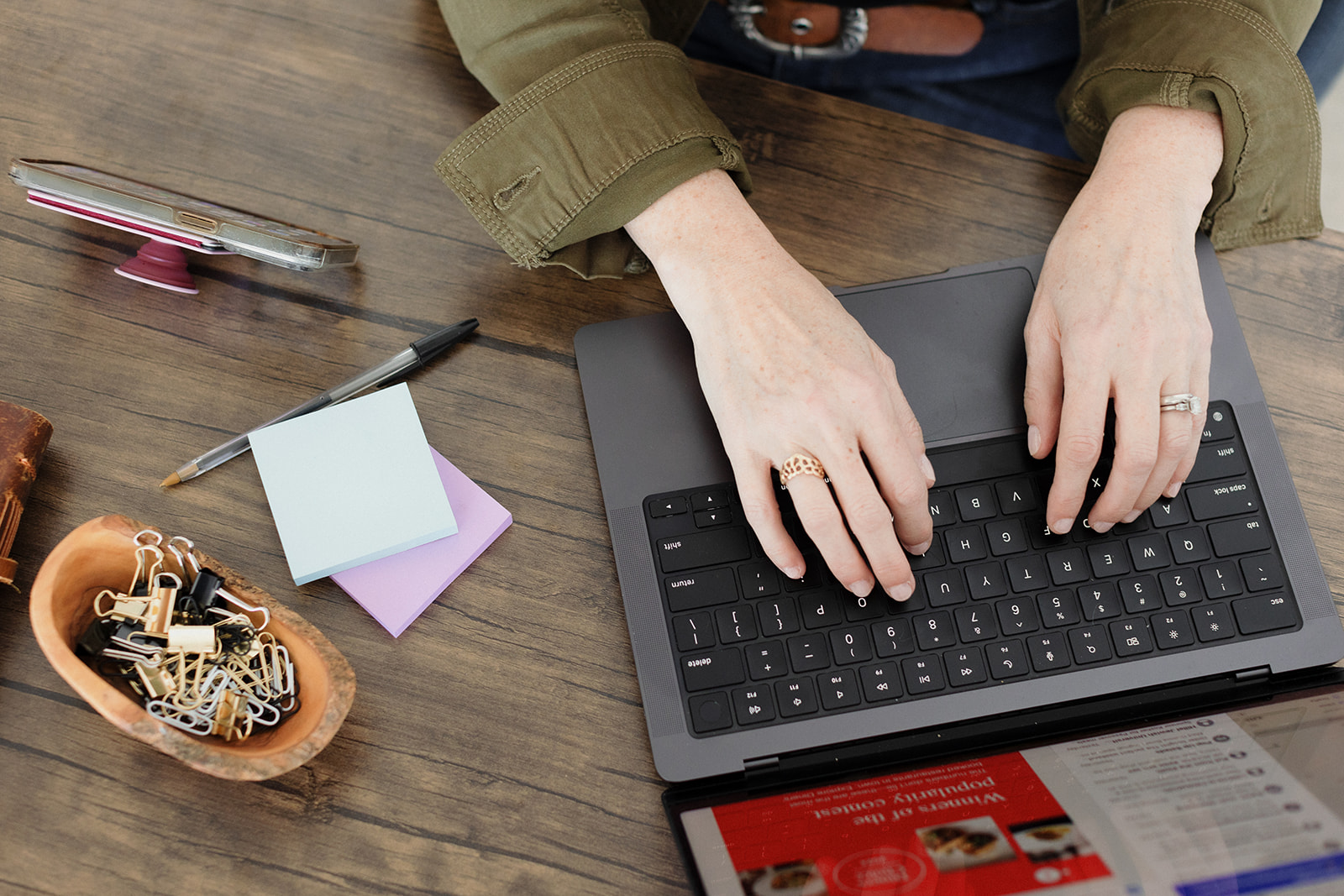 woman's hands typing on a laptop from overhead brand web design