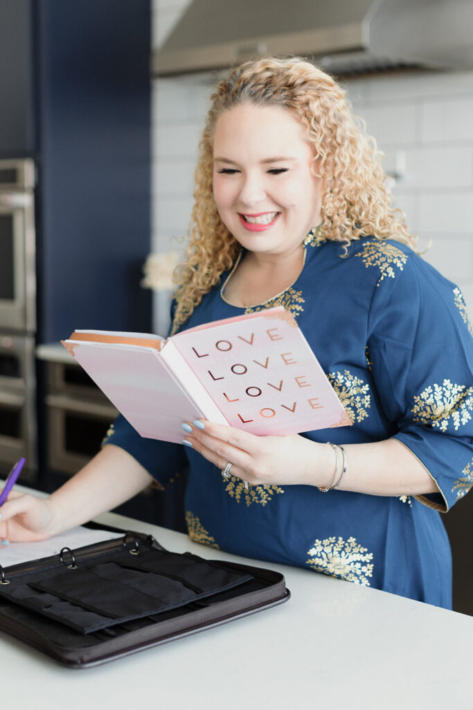 ceremony officiant planning a wedding with a book on love at the kitchen counter Chicago branding mini sessions