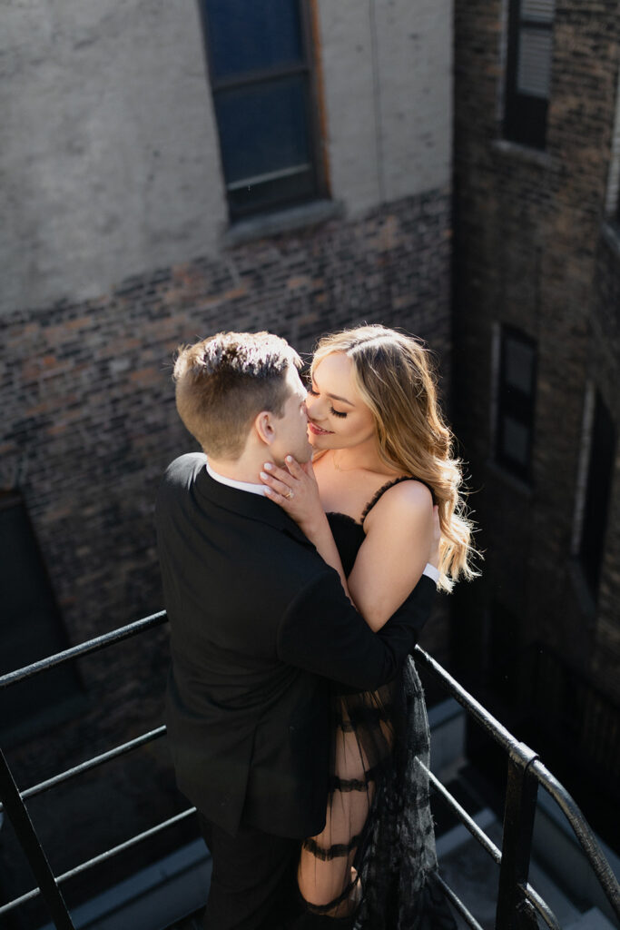 couple kissing on fire escape Romantic River North engagement session