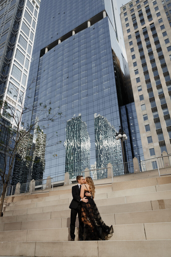 couple kissing on steps at Chicago Riverwalk Romantic River North engagement session