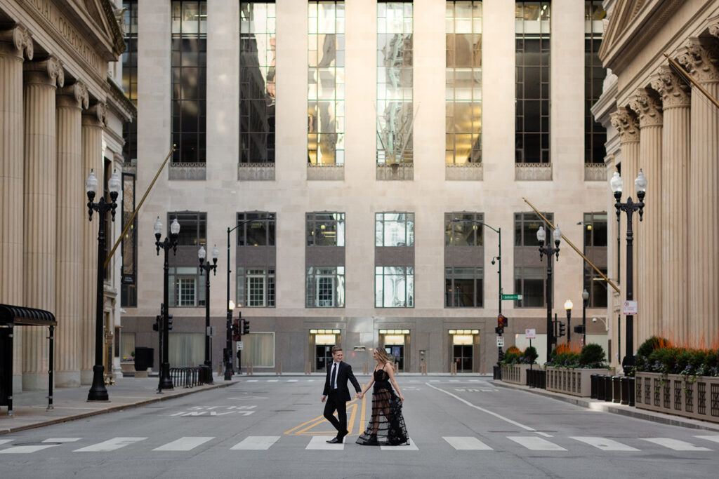 couple walking across street in Financial District Chicago Romantic River North engagement session