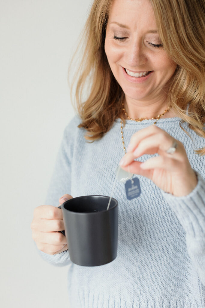 woman putting tea bag in her mug, you need a strategy for your brand photos