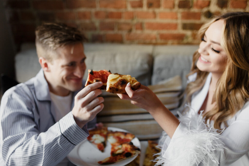 couple having a private pizza party Romantic River North engagement session