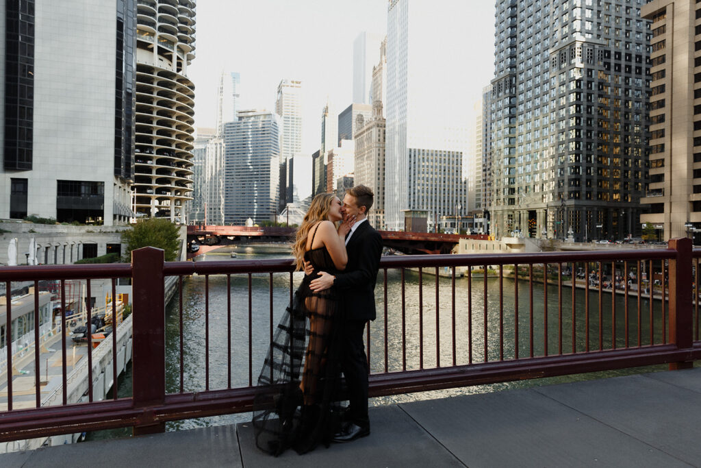 couple kissing on Chicago bridge Romantic River North engagement session