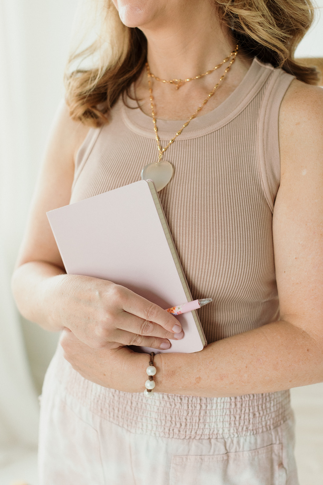 woman holding planner with a pen