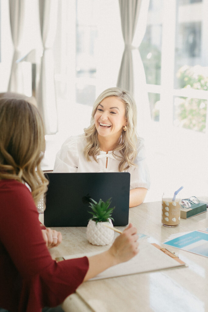 Service-based business owner smiling while working with a client, showing what it feels like to work with her