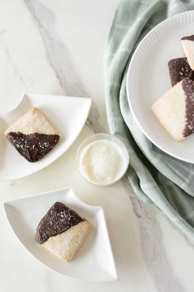 shortbread cookies arranged on plate for brand photos with milk