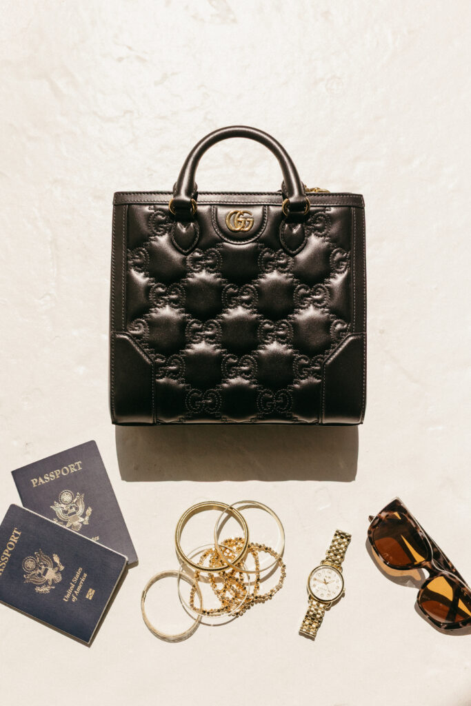 Luxury travel with passport and jewelry brand photos flat lay