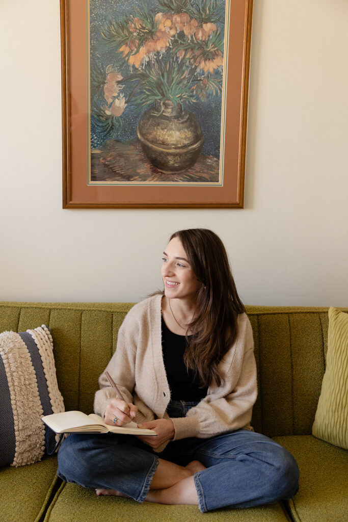 Therapy practice brand photos with a journal on a green couch