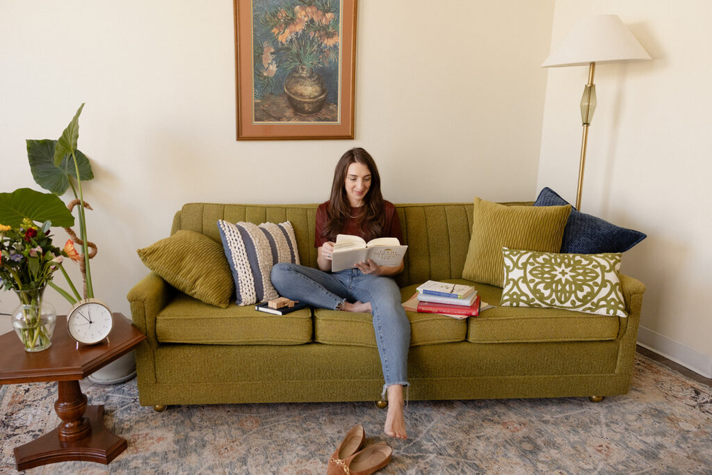 Therapist brand photos with reading on an office couch