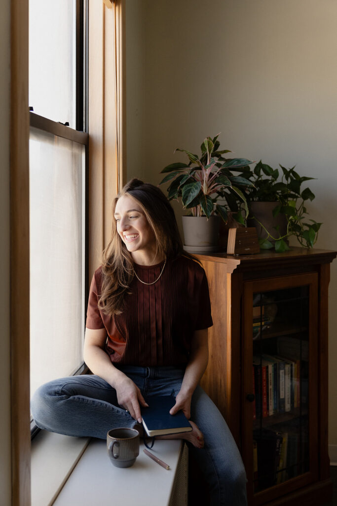 Chicago therapist reading in an office window nook during a brand session