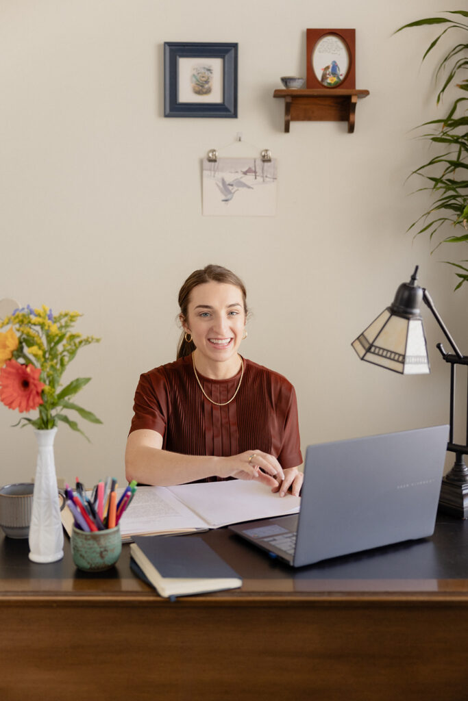 Chicago therapist smiling at desk brand session