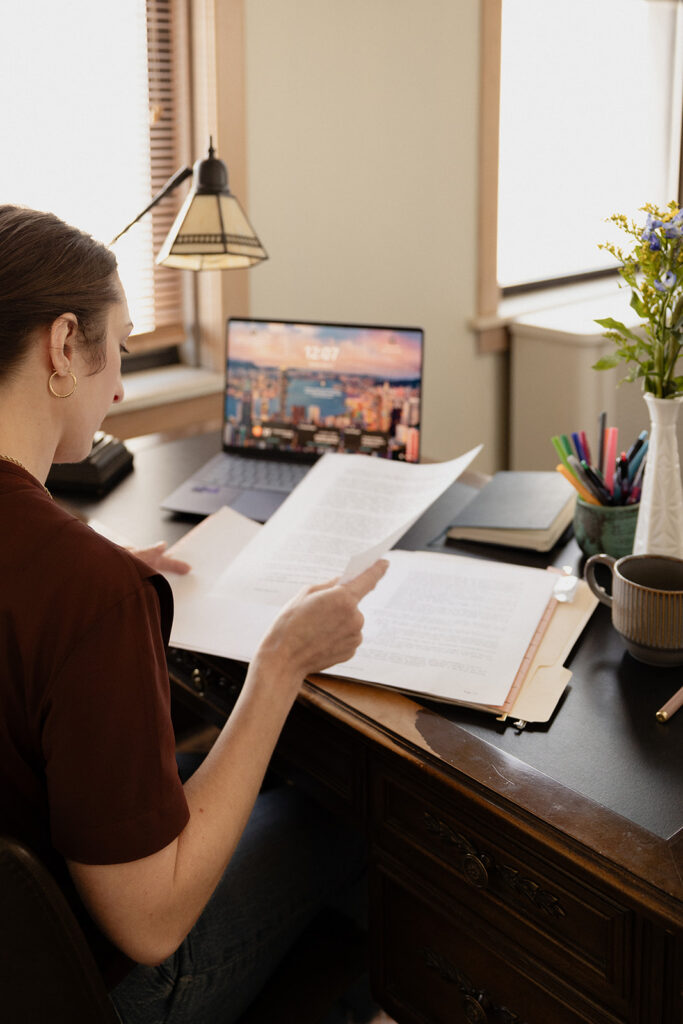 Therapist brand photos reading files at a vintage desk in a Chicago private practice