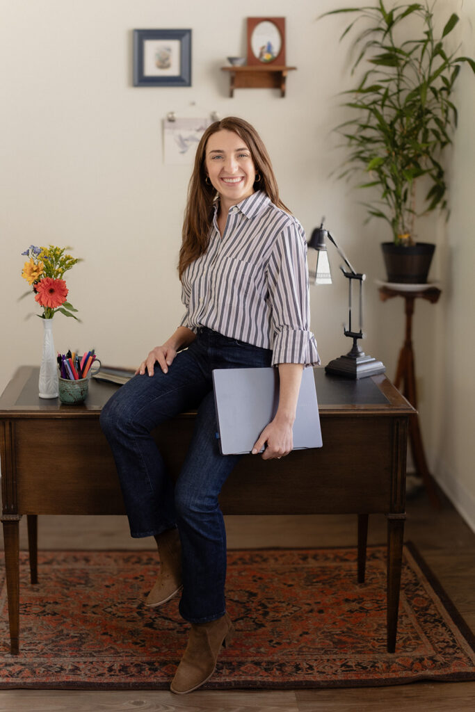 Chicago therapist headshot from a brand photography session sitting on vintage desk